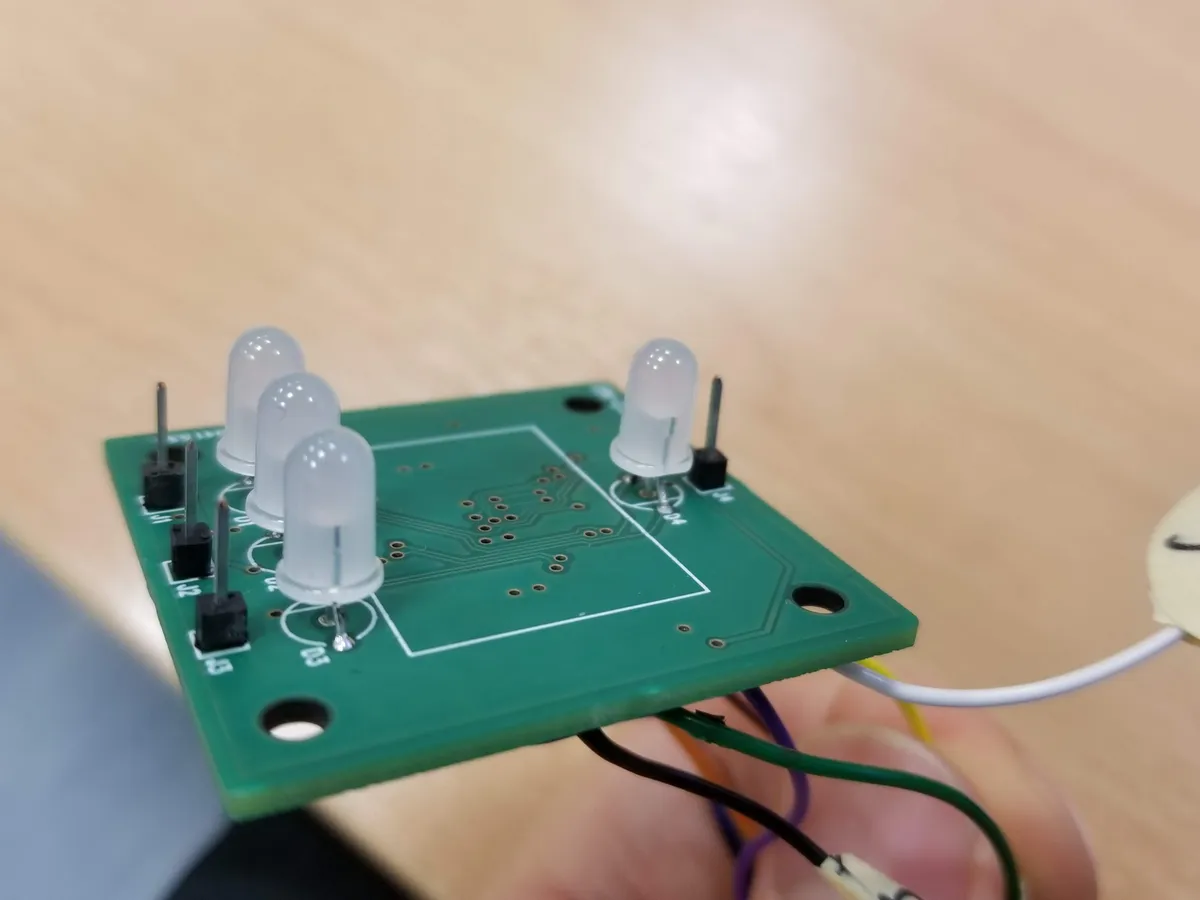 Populated module being tested with LEDs lit up on the workbench