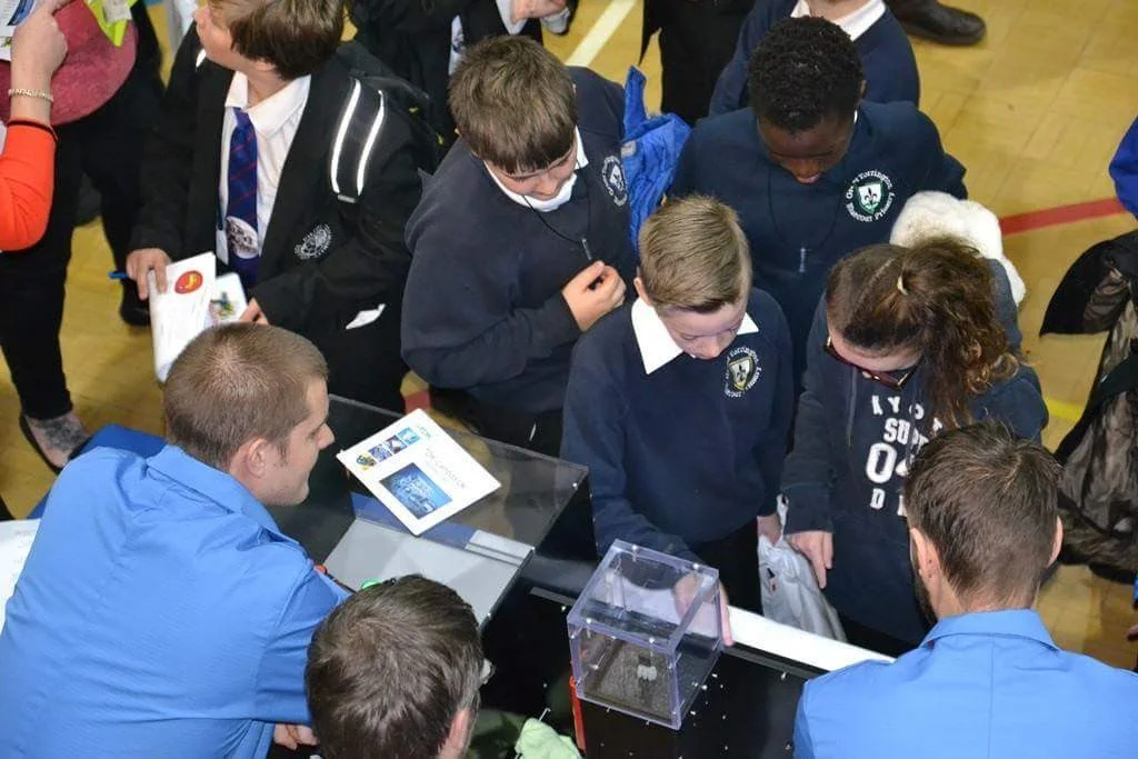 School students gathered around the Simon Says game at Big Bang Fair